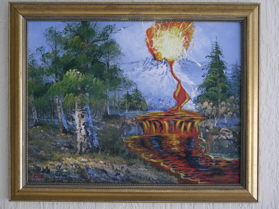 contemporary fine art upcycled painting of a moountain and stream converted into an erupting volcano and lava flow on recycled charity shop painting in the style of Bob Ross by saatchiart artist Christian Dodd